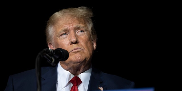 FILE - Former President Donald Trump pauses while speaking at a rally at the Minden Tahoe Airport in Minden, Nevada, on Oct. 8, 2022.