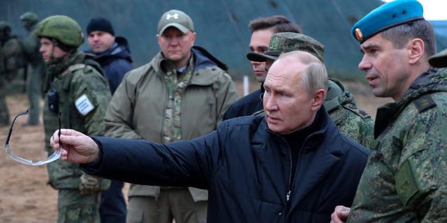 Russian President Vladimir Putin gestures as he visits a military training center in Ryazan Region, Russia, on Oct. 20, 2022.