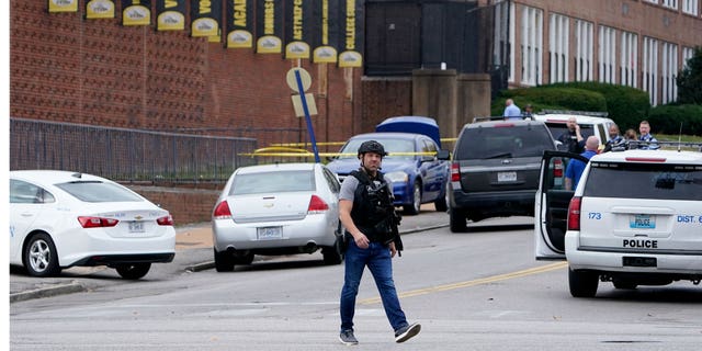 Officers investigate a shooting at Central Visual and Performing Arts High School Monday, Oct. 24, 2022, in St. Louis.