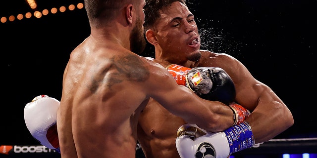 Vasiliy Lomachenko punches Jamaine Ortiz, right, during a lightweight boxing match Saturday, Oct. 29, 2022, in New York. 