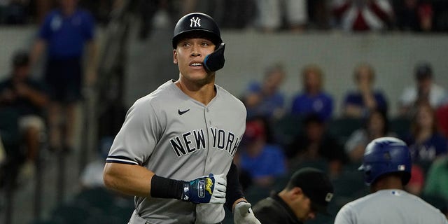 New York Yankees' Aaron Judge heads to the dugout after grounding out during the first inning in the first baseball game of a doubleheader against the Texas Rangers in Arlington, Texas, Tuesday, Oct. 4, 2022.