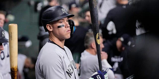 New York Yankees Aaron Judge stands in the dugout ahead of Game 1 of baseball's American League Championship Series between the Houston Astros and the New York Yankees, Wednesday, Oct. 19, 2022, in Houston.