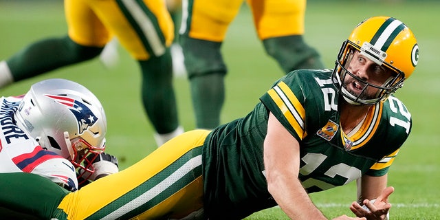 Aaron Rodgers (12) of the Green Bay Packers reacts after being hit in overtime against the New England Patriots at Lambeau Field on Oct. 2, 2022, in Green Bay, Wisconsin.