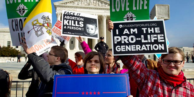 In this Jan. 18, 2019, photo, pro-life activists protest outside of the U.S. Supreme Court, during the March for Life in Washington.