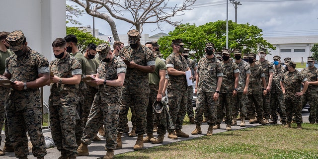 U.S. Marines queue to receive the Moderna coronavirus vaccine at Camp Hansen in Kin, Japan, on April 28, 2021.