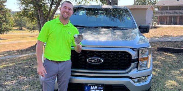 Austin Clagett poses with his hole-in-one ball and what he thought would be his prize.