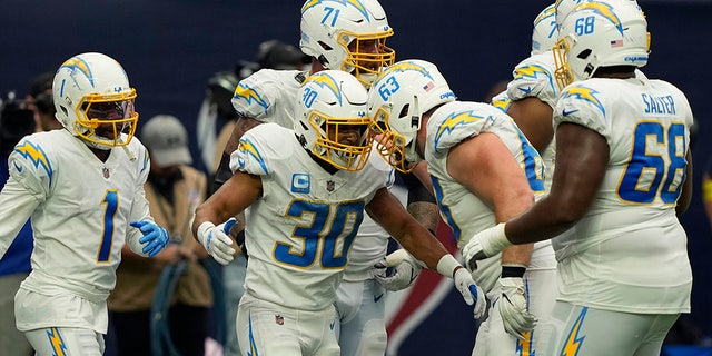 Los Angeles Chargers running back Austin Ekeler (30) celebrates with teammates after scoring a touchdown against the Houston Texans during the second half of an NFL football game Sunday, Oct. 2, 2022, in Houston. 