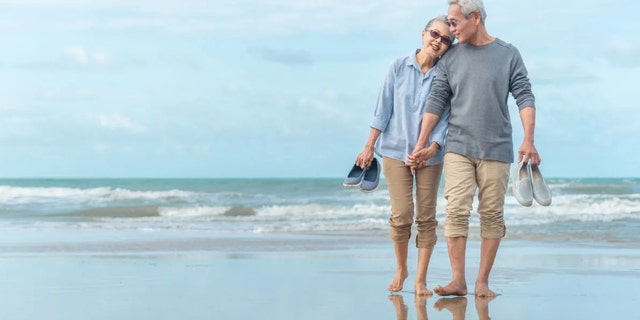 A couple walk on the beach