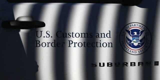 NOGALES, AZ - DECEMBER 09: A U.S. Border Patrol vehicle sits parked next to the U.S.-Mexico border fence on December 9, 2014, in Nogales, Arizona. 