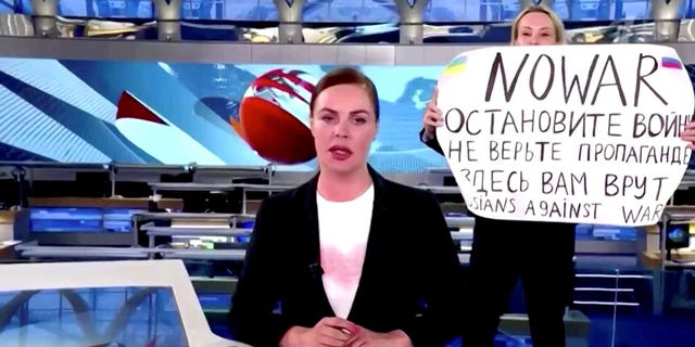 Marina Ovsyannikova  interrupts a live news bulletin on Russia's state TV "Channel One" holding up a sign that reads, "NO WAR. Stop the war. Don't believe propaganda. They are lying to you here." at an unknown location in Russia March 14, 2022.