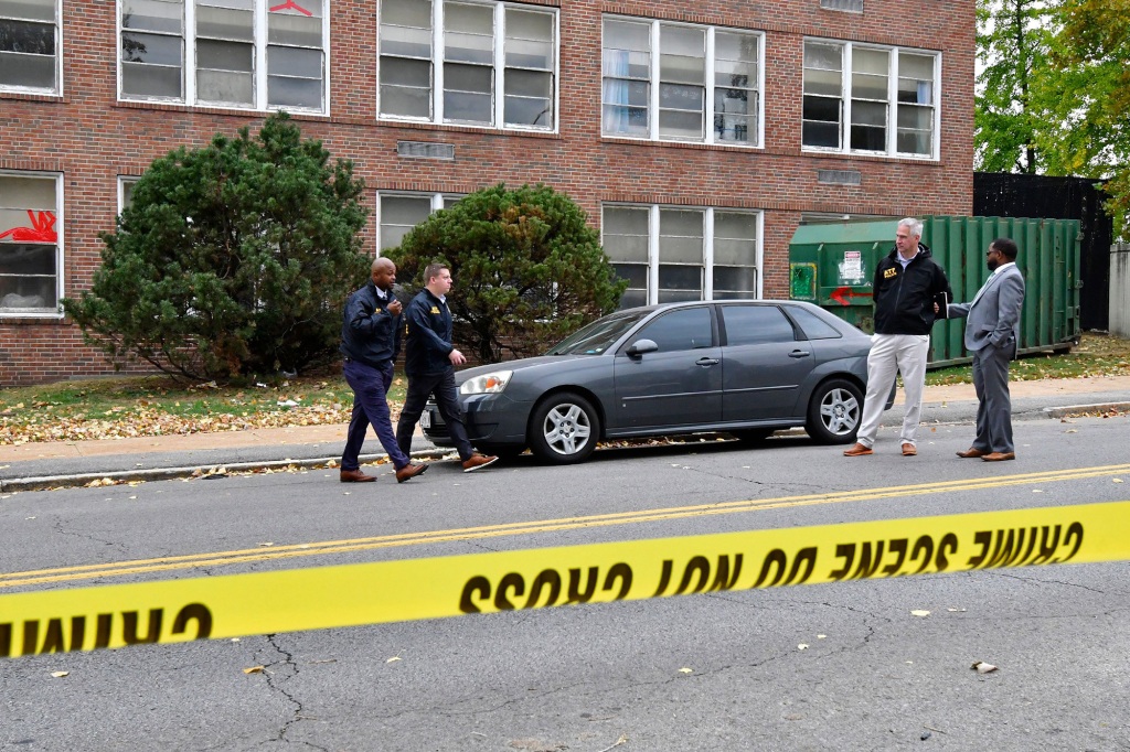 St. Louis Metropolitan police and Alcohol, Tobacco & Firearms officers stand outside the Central Visual and Performing Arts High School after a shooting that left three people dead including the shooter in St Louis, Missouri on October 24, 2022.