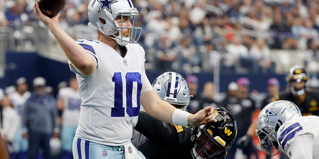 Dallas Cowboys quarterback Cooper Rush, #10, throws a pass under pressure from Washington Commanders defensive end Montez Sweat, right, in the second half of an NFL football game in Arlington, Texas, Sunday, Oct. 2, 2022. 