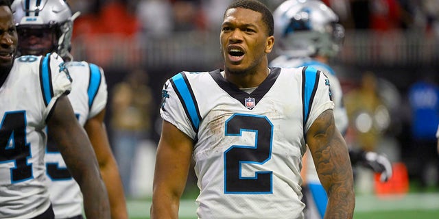 Carolina Panthers wide receiver DJ Moore removes his helmet after catching a touchdown pass during the second half of an NFL football game against the Atlanta Falcons Sunday, Oct. 30, 2022, in Atlanta. Moore was charged with a 15-yard unsportsmanlike penalty for removing his helmet on the play.