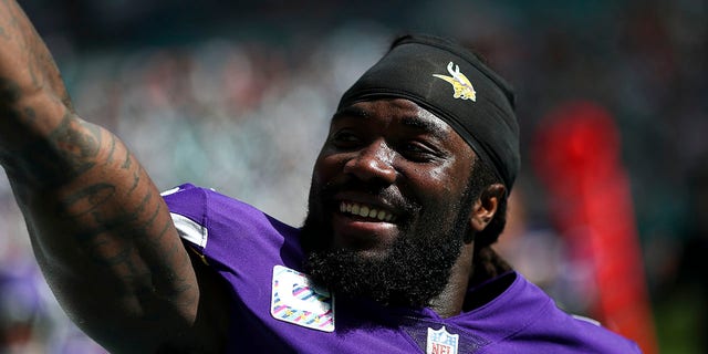 Dalvin Cook, #4 of the Minnesota Vikings, smiles and celebrates with fans after scoring a touchdown during an NFL football game against the Miami Dolphins at Hard Rock Stadium on Oct. 16, 2022 in Miami Gardens, Florida. 