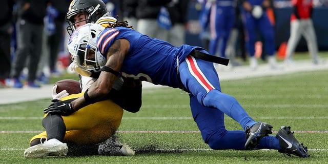 Damar Hamlin, right, of the Buffalo Bills tackles Kenny Pickett of the Pittsburgh Steelers during the fourth quarter at Highmark Stadium Oct. 9, 2022, in Orchard Park, N.Y.