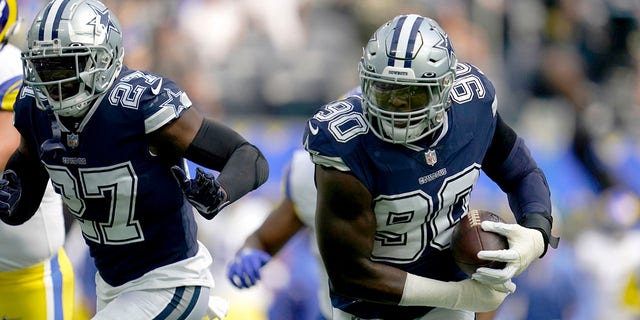 Dallas Cowboys safety Jayron Kearse (27) helps defend as defensive end DeMarcus Lawrence (90) returns a Los Angeles Rams' Matthew Stafford fumble for a touchdown in the first half of an NFL football game, Sunday, Oct. 9, 2022, in Inglewood, Calif.