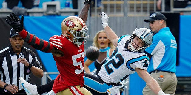 San Francisco 49ers linebacker Dre Greenlaw breaks up a pass intended for Panthers running back Christian McCaffrey on Sunday, Oct. 9, 2022, in Charlotte, North Carolina.