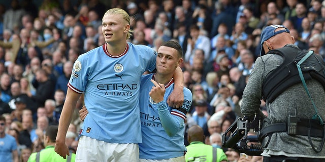 Manchester City's Phil Foden, right, celebrates with his teammate Erling Haaland after scoring his side's sixth goal and his personal hat trick during the English Premier League soccer match between Manchester City and Manchester United at Etihad stadium in Manchester, England, Sunday, Oct. 2, 2022. 