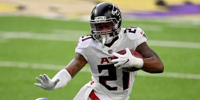 Todd Gurley of the Atlanta Falcons runs with the ball while being tackled by Cameron Dantzler of the Minnesota Vikings at U.S. Bank Stadium Oct. 18, 2020, in Minneapolis.