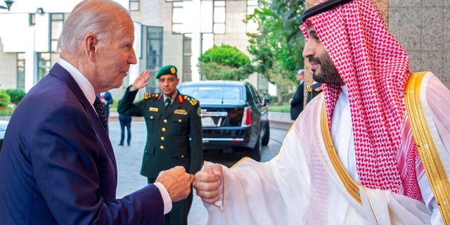 In this image released by the Saudi Royal Palace, Saudi Crown Prince Mohammed bin Salman, right, greets President Biden with a fist bump after his arrival at Al-Salam palace in Jeddah, Saudi Arabia, July 15, 2022.  