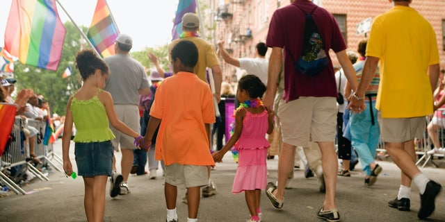 Stock image of children marching in a Gay Pride parade.