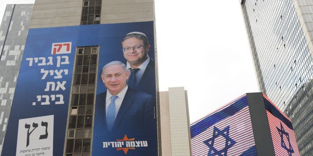 An election campaign poster in 2021 for far-right Otzma Yehudit (Jewish Power) with images of party leader Itamar Ben-Gvir behind Benjamin Netanyahu, the former Israeli prime minister. (Artur Widak/NurPhoto via Getty Images)