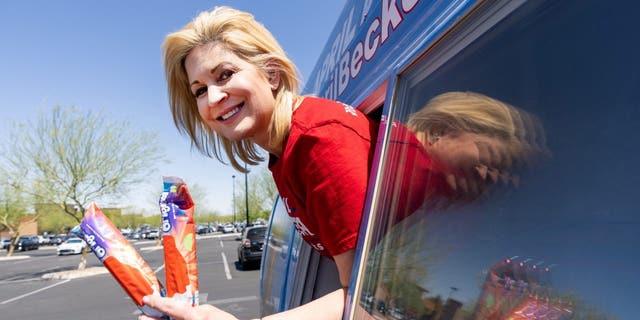 Republican candidate for U.S. Congress April Becker poses in the window of her campaign van, a converted ice cream truck, in Las Vegas, Nev. on Sunday, May 29, 2022.