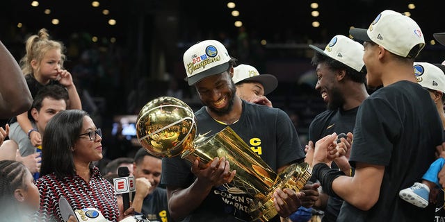 Andrew Wiggins of the Golden State Warriors celebrates with The Larry O'Brien Trophy after Game 6 of the 2022 NBA Finals June 16, 2022, at TD Garden in Boston. 