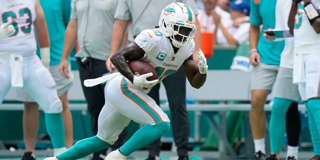 Miami Dolphins wide receiver Tyreek Hill (10) runs after the catch during a game against the New England Patriots Sept. 11, 2022, at Hard Rock Stadium in Miami Gardens, Fla. 