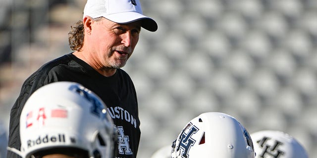 Houston Cougars head coach Dana Holgorsen chats with team members before the football game between the Tulane Green Wave and Houston Cougars at TDECU Stadium on September 30, 2022, in Houston, TX. 