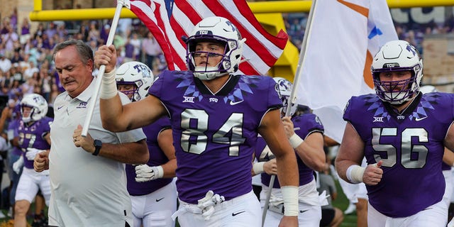 TCU Horned Frogs head coach Sonny Dykes and tight end Dominic DiNunzio (84) run onto the field before a game against the Tarleton State Texans Sept. 10, 2022, at Amon G. Carter Stadium in Fort Worth, Texas. 