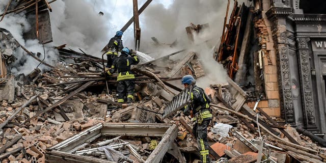 Ukrainian firefighters push out a fire after a strike in Zaporizhzhia on Oct. 6, 2022, amid the Russian invasion of Ukraine.