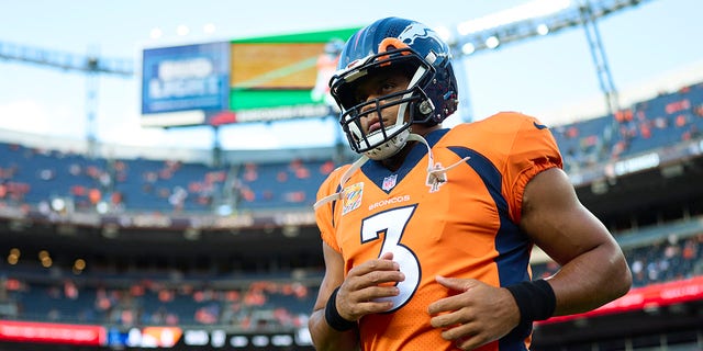 Russell Wilson of the Denver Broncos warms up before kickoff against the Indianapolis Colts at Empower Field at Mile High on Oct. 6, 2022, in Denver.