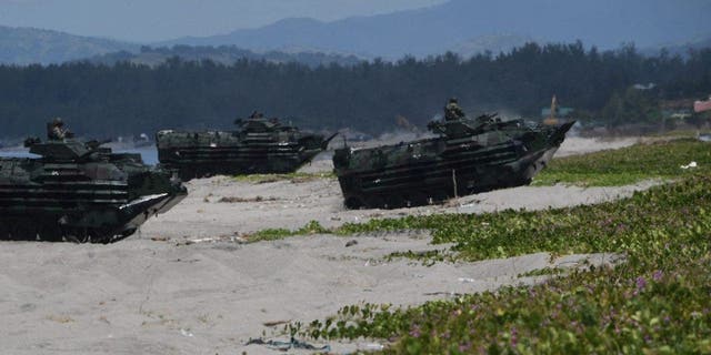 Filipino amphibious assault vehicles roll in during a joint amphibious landing exercise with U.S. Marines at a beach overlooking the South China Sea in San Antonio town, Zambales province, Oct. 7, 2022.