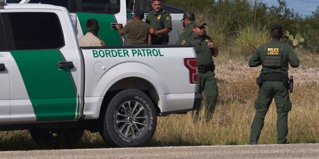 An illegal migrant smuggled in a vehicle is apprehended by US Border Patrol and the Webb County Sheriff's Office on October 12, 2022, in Laredo, Texas. 