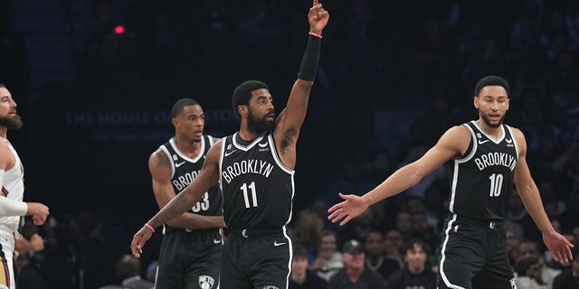 Kyrie Irving of the Nets points during the New Orleans Pelicans game on Oct. 19, 2022, at Barclays Center in Brooklyn, New York.