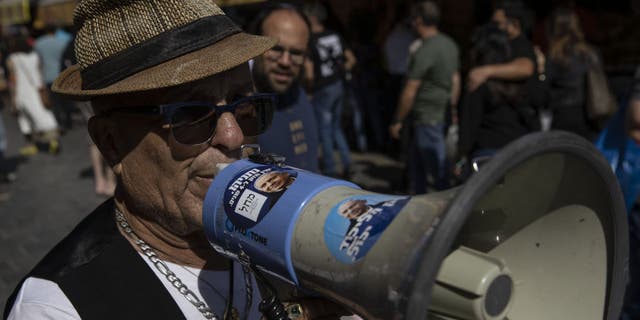 Supporters of Benjamin Netanyahu, leader of the opposition and chairman of the Likud National Liberal Movement, march on the street as Israeli voters will cast ballots Nov. 1 to elect members of the Knesset, the fifth legislative polls in less than four years, in Jerusalem Oct. 28, 2022.