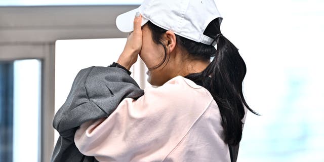 A relative of missing persons following the Itaewon Halloween stampede reacts as she waits for updates at the Hannam-dong Community Center in Seoul. JUNG YEON-JE/AFP via Getty Images)