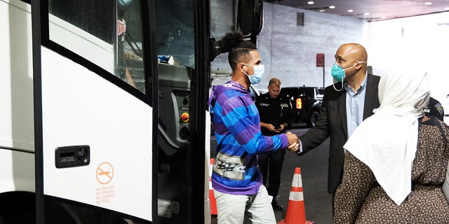 Migrants who crossed the border from Mexico into Texas exit a bus as it arrives at the Port Authority bus station in Manhattan 