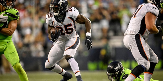 Melvin Gordon III, #25, of the Denver Broncos runs with the ball against the Seattle Seahawks during the second half of Seattle's 17-16 win at Lumen Field on Monday, Sept. 12, 2022. 