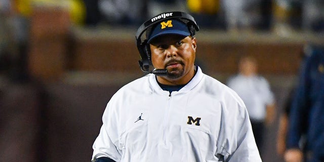 Blake Corum #2 (L) and Assistant Coach Mike Hart (R) of the Michigan Wolverines are seen during the second half of a college football game against the Hawaii Rainbow Warriors at Michigan Stadium on Sept. 10, 2022 in Ann Arbor, Michigan. The Michigan Wolverines won the game 56-10 over the Hawaii Rainbow Warriors. 