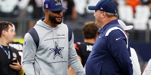 Dak Prescott of the Dallas Cowboys and head coach Mike McCarthy visit during warmups before a game against the Cincinnati Bengals Sept. 18, 2022, in Arlington, Texas. 