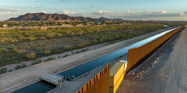 In this aerial view, Cuban immigrants seeking asylum in the United States await transport by the U.S. Customs and Border Protection after they crossed into Arizona from Mexico on Sept. 27, 2022, in Yuma, Arizona. 