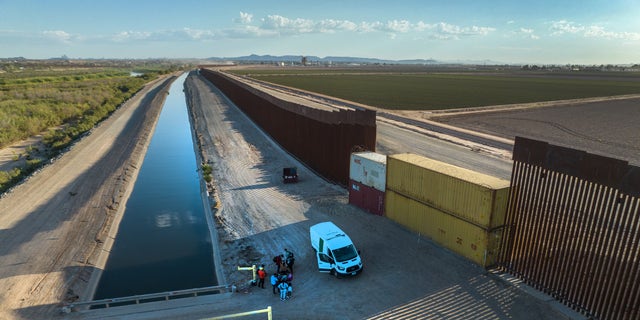 Shipping containers fill gaps in the border wall in Yuma, Arizona. 