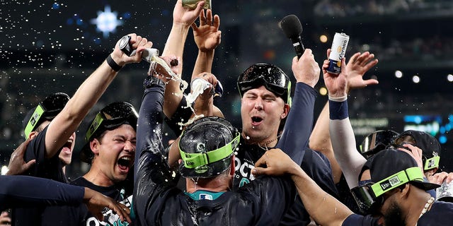 Manager Scott Servais #9 of the Seattle Mariners celebrates after clinching a postseason birth after beating the Oakland Athletics 2-1 at T-Mobile Park on September 30, 2022, in Seattle, Washington. The Seattle Mariners have clinched a postseason appearance for the first time in 21 years, the longest playoff drought in North American professional sports. 