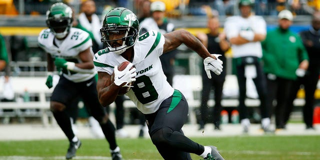 Elijah Moore #8 of the New York Jets runs with the ball in the first quarter against the Pittsburgh Steelers at Acrisure Stadium on October 2, 2022, in Pittsburgh, Pennsylvania. 
