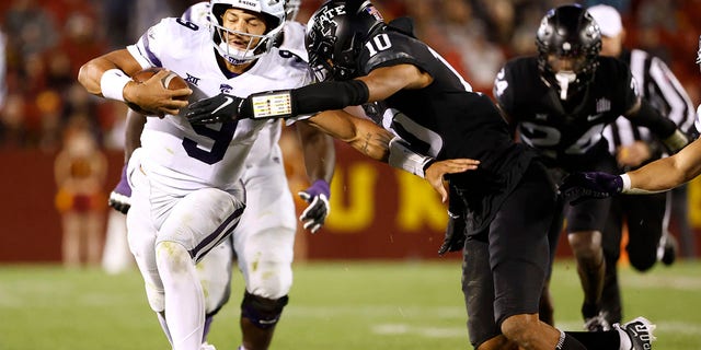 Quarterback Adrian Martinez, #9 of the Kansas State Wildcats, is tackled by defensive back Darien Porter, #10 of the Iowa State Cyclones, as he scrambles for yards in the second half of play at Jack Trice Stadium on Oct. 8, 2022 in Ames, Iowa. The Kansas State Wildcats won 10-9 over the Iowa State Cyclones. 