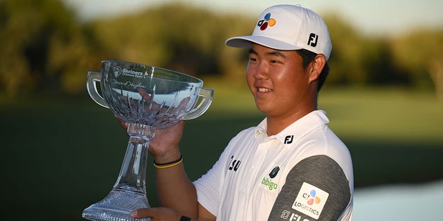 Tom Kim of South Korea poses with the trophy after winning the Shriners Children's Open at TPC Summerlin on Oct. 9, 2022 in Las Vegas, Nevada. 