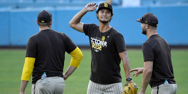 Yu Darvish of the San Diego Padres, center, talks to teammates before Game 1 of the NLDS against the Los Angeles Dodgers on Oct. 11, 2022, in Los Angeles.