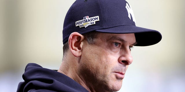 Manager Aaron Boone #17 of the New York Yankees looks on against the Houston Astros during the third inning in game two of the American League Championship Series at Minute Maid Park on Oct. 20, 2022 in Houston, Texas. 